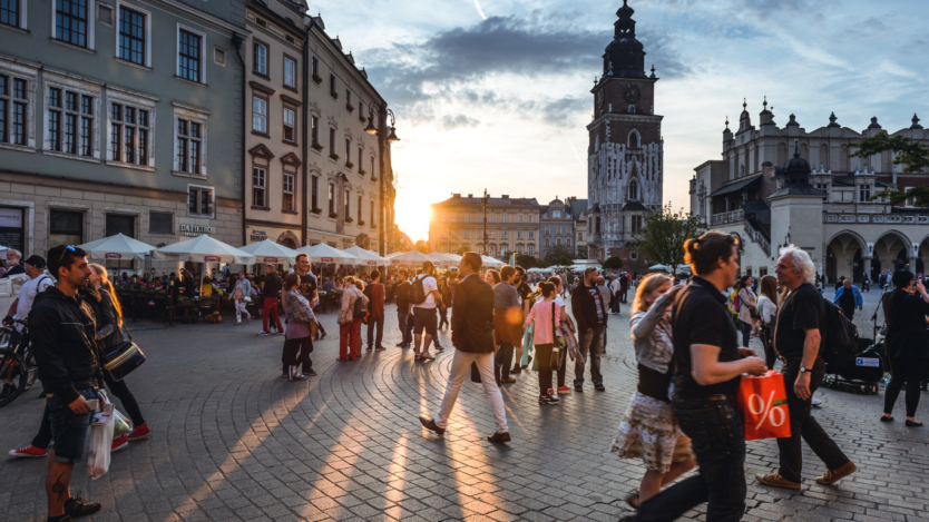 People walking in a square in the EU at sunset