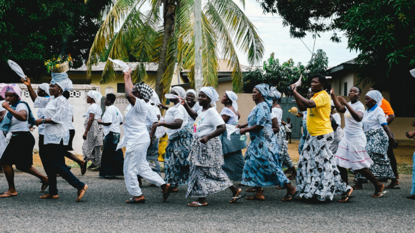 people dancing in a street in Ghana