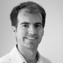 Black and white photograph of Alvaro Oleart smiling.